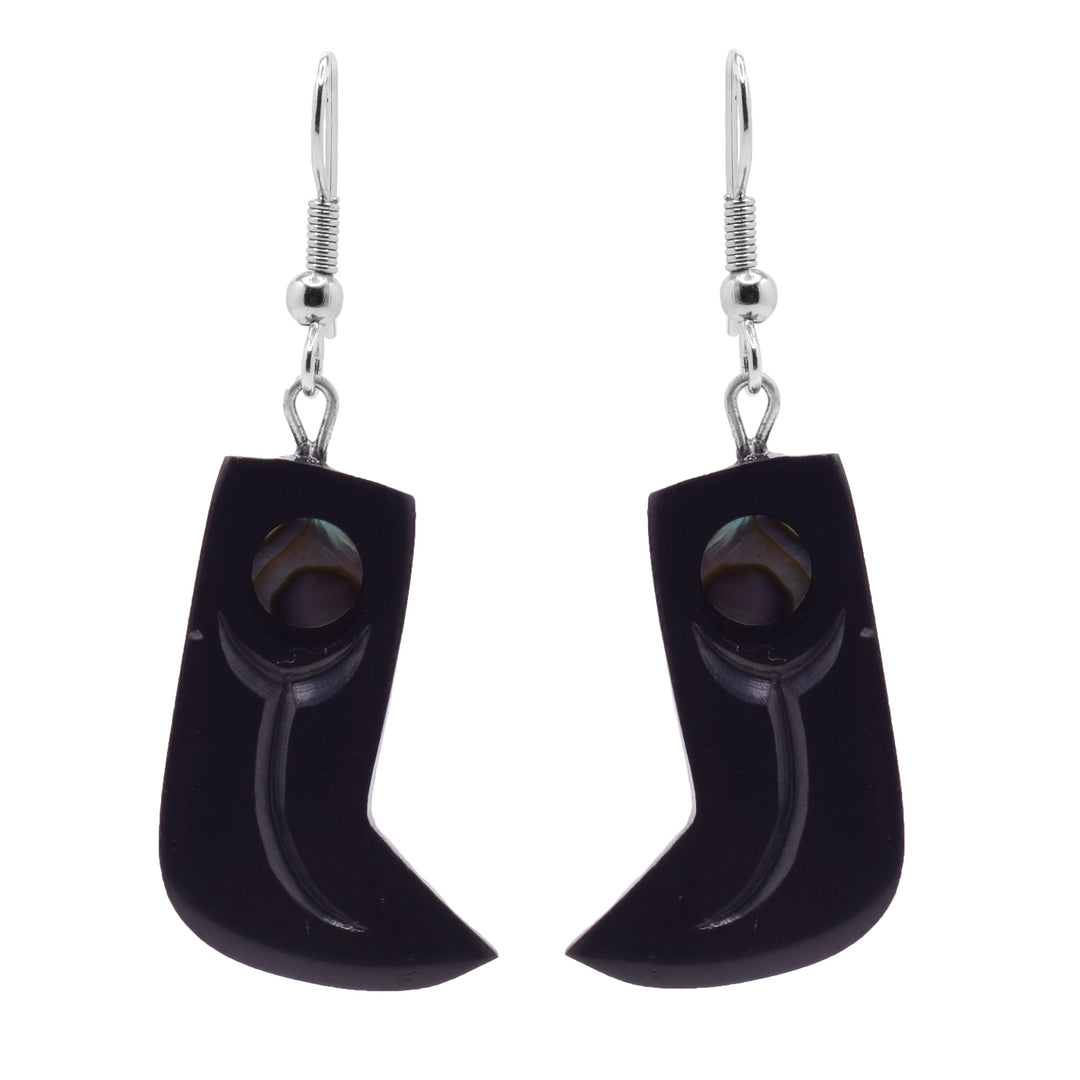 These dangling claw earrings have hangs made from argillite stone. The earrings are rectangular and drop down. They curve sharply to the side at the end and the ends are pointed. There are abalone pieces at the top by the hooks and designs carved into the hangs.