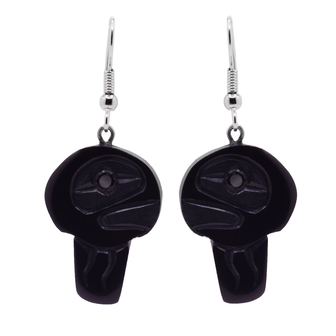 These jellyfish earrings have large hangs made from argillite stone. The hangs are shaped like a jelly fish with a round top and a rectangle portion extending from the bottom for the tentacles. There are carvings on the surface of the hangs detailing the eye and tentacles of the jellyfish.