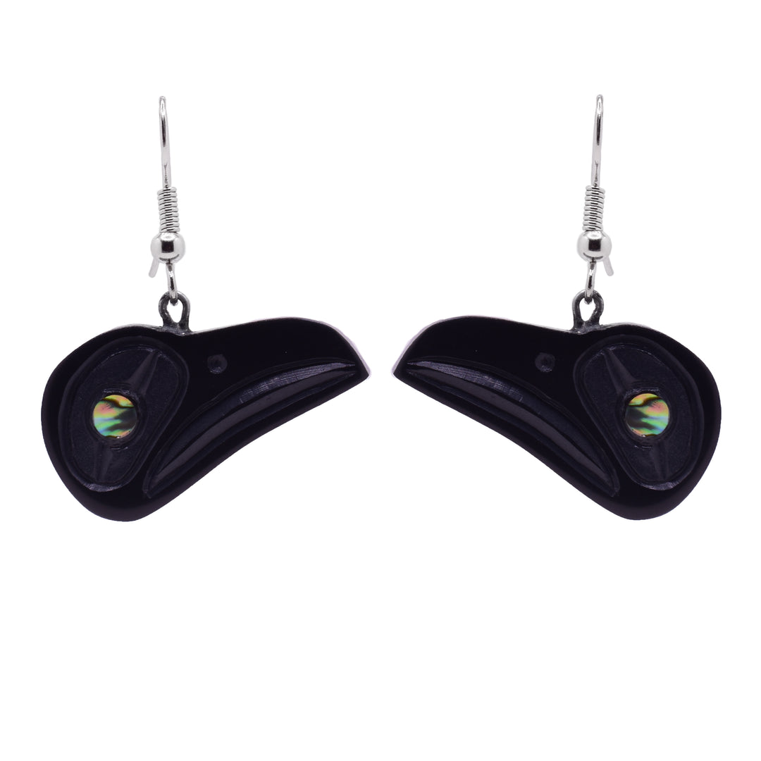 These large Raven earrings have hangs carved from argillite stone and dangle from the hooks. The hangs are shaped like the head of the Raven at a side profile. Its beak is long and wide and there is an abalone shell gem set in its eye.