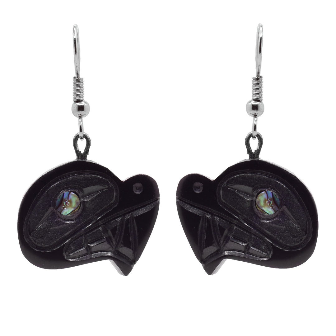 These Haida earrings have chunky hangs made from argillite stone. They are shaped like and have carvings on the surface detailing the large teeth, nose and eye of the Orca. There is an abalone shell gem set in the eye.