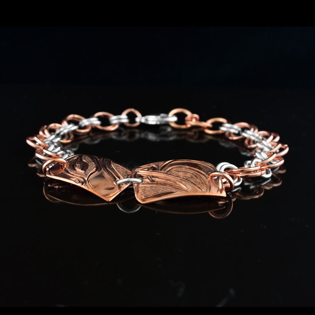 This sterling silver copper chain bracelet has double copper links hooped through double silver links to make the chain. There are two, rectangle and copper plates at the top with the head of the Wolf and Eagle carved into them.