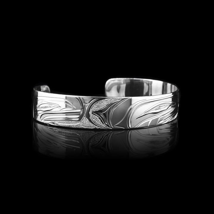 Orca Bracelet is carved into the half an inch wide cuff made with sterling silver.