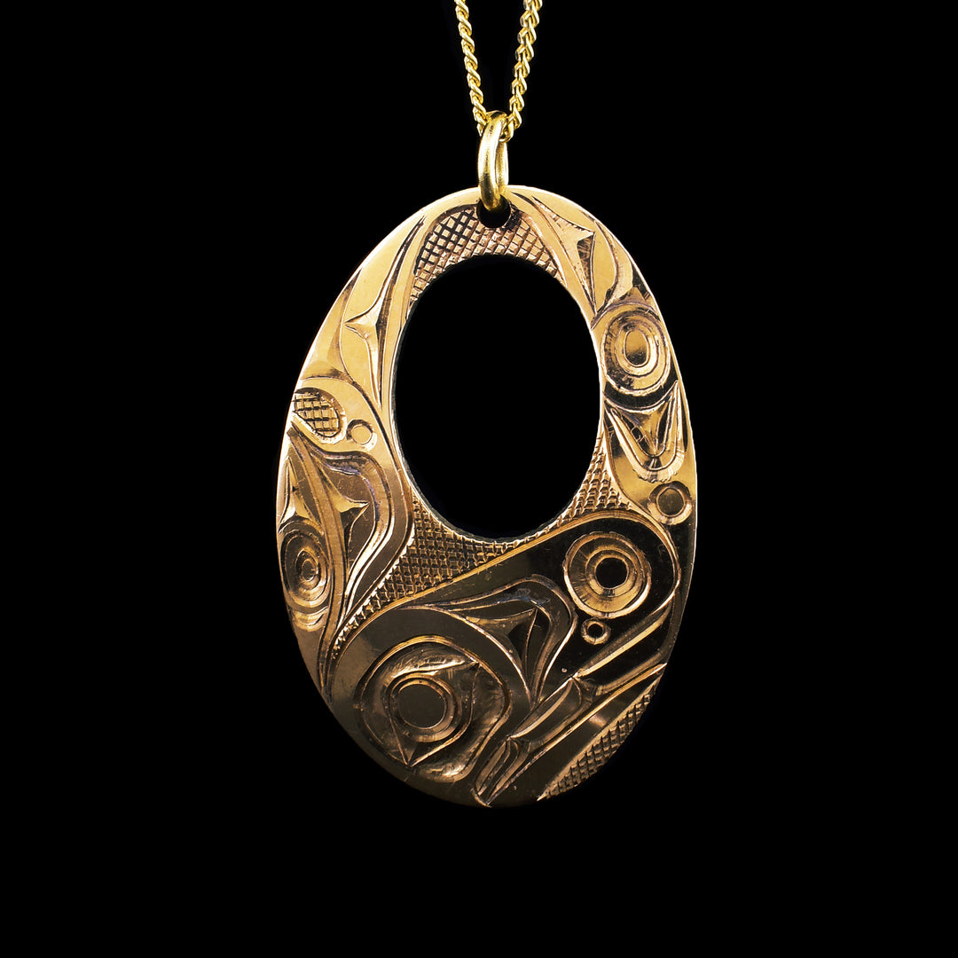 his handcrafted 14K gold pendant by Haida artist Jim McGuire features a finely carved Orca design, symbolizing strength, unity, and the spirit of the ocean. A striking piece of Northwest Coast Indigenous art.