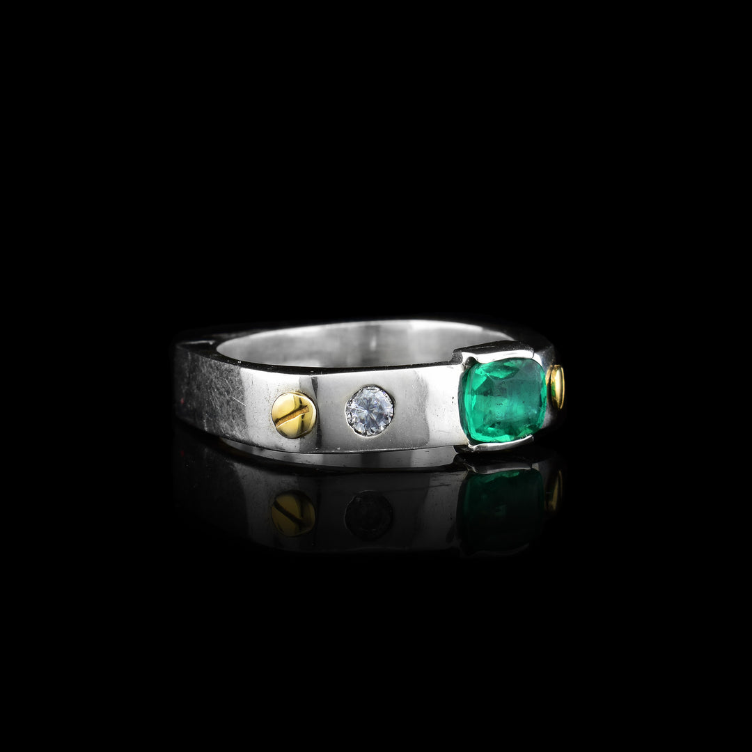 A statement with this unique artisan ring by Ivan Dobren. Handcrafted with sterling silver and 14k gold, it beautifully showcases a vibrant, circular green emerald at its center with a diamond on its side.