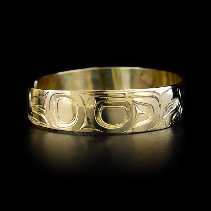This 14K gold Orca bracelet has a depiction of the Orca carved into the surface of the band.
