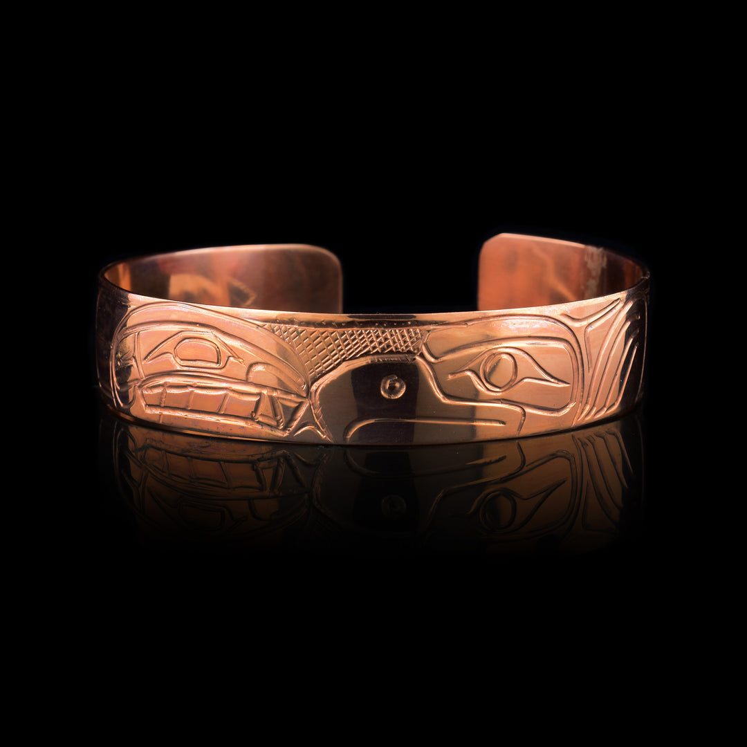 this half inch wide copper cuff has been hand carved with an Orca and Eagle on the surface both facing each other.