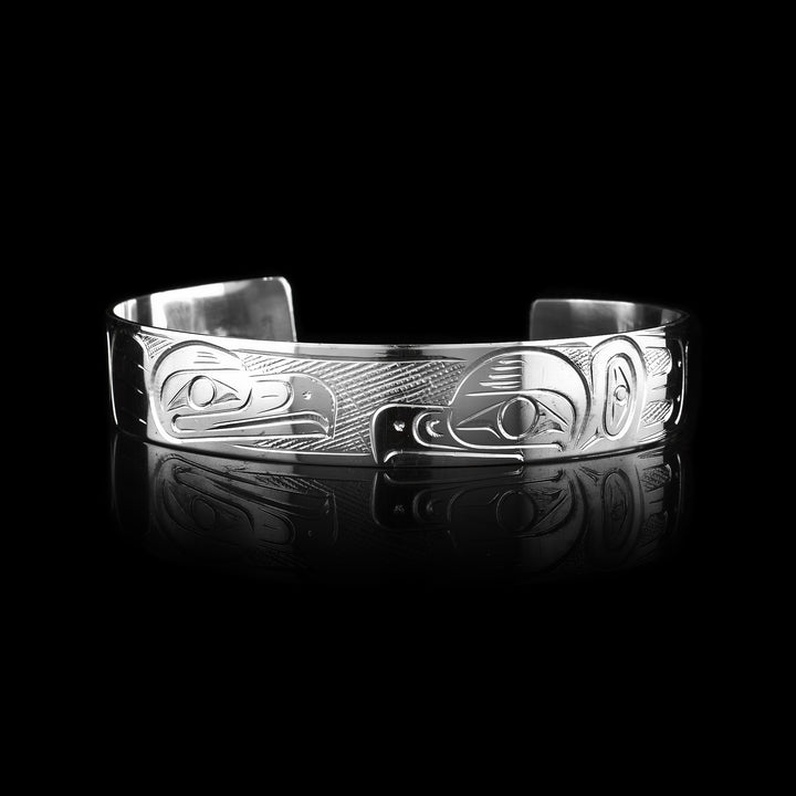1/2" Sterling Silver Double Eagle Cuff Bracelet - Sold at Artina's this sterling silver cuff has been hand carved by  Coast Salish artist Graham Henry. The legend of the Eagle is carved into the surface.
