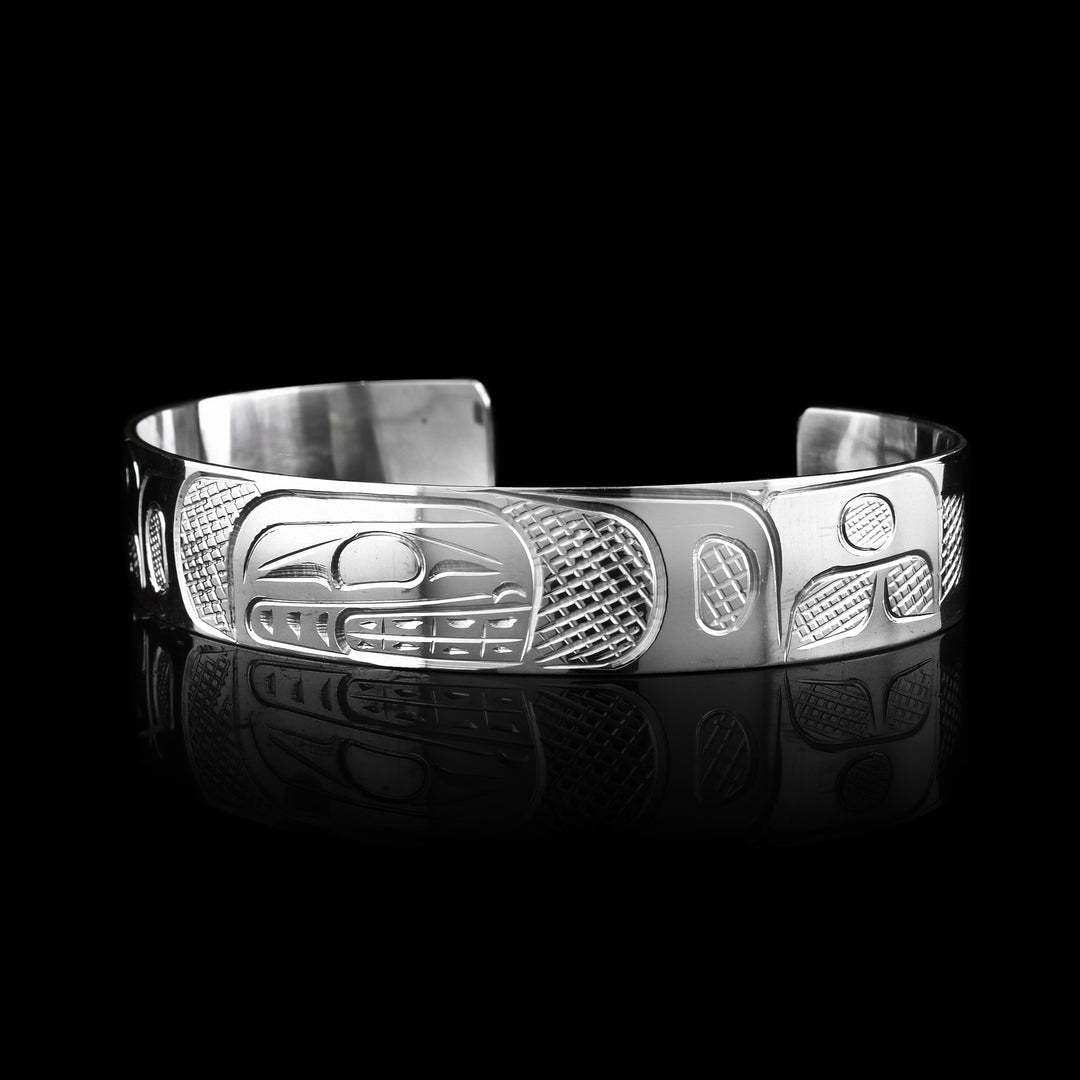 1/2" Sterling Silver Orca Bracelet Cuff, it has been hand carved by Coast Salish artist Graham Henry. Sold at Artina's the Orcas side profile is carved at the top on the bracelet.
