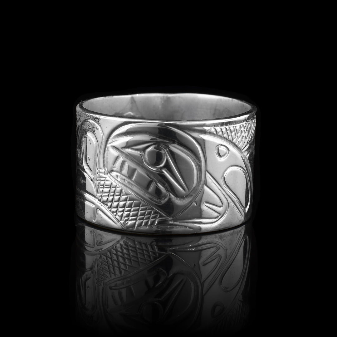 This sterling silver band ring is hand carved with the legend of the orca