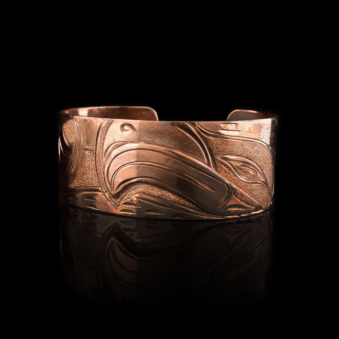 Hand-carved 1" wide Copper Eagle Cuff Bracelet by Kwakwaka'wakw artist Cristiano Bruno. This elegant Indigenous statement piece features traditional Northwest Coast formline engraving and a high-polish Eagle legend.