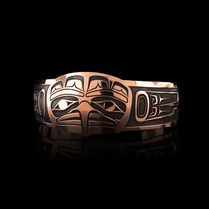his oxidized copper Eagle bracelet by Tahltan artist Grant Pauls. Hand-carved with stunning depth, this cuff is a masterpiece of Indigenous art.
