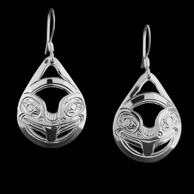 These dangling Frog earrings are made from sterling silver and have teardrop shaped hangs. There are cutouts and carvings on the surface of the hangs that depict the Frog.