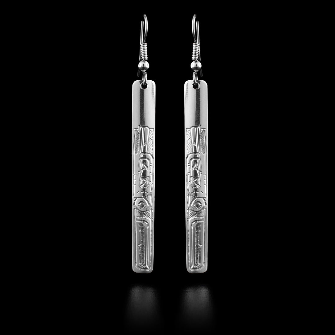 These sterling silver Hummingbird drop earrings have long, thin and rectangle shaped hangs. There are beautiful carvings on the surface of the hangs that depict the Hummingbird at a side profile. Its head is looking upward and there are wing designs behind the head.