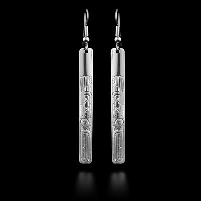 These sterling silver Hummingbird drop earrings have long, thin and rectangle shaped hangs. There are beautiful carvings on the surface of the hangs that depict the Hummingbird at a side profile. Its head is looking upward and there are wing designs behind the head.