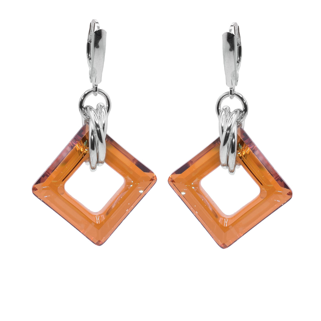These dangle hoop earrings have square shaped hoop hangs made from copper Swarovski crystals. The crystals have three sterling silver hoops linked through them and those hoops are linked through a smaller one attached to the hooks.