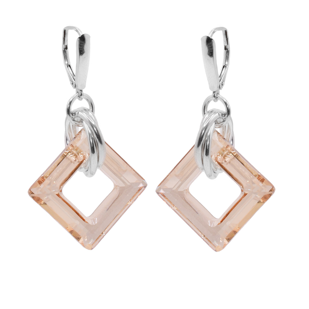 These dangle hoop earrings have square shaped hoop hangs made from champagne Swarovski crystals. The crystals have three sterling silver hoops linked through them and those hoops are linked through a smaller one attached to the hooks.