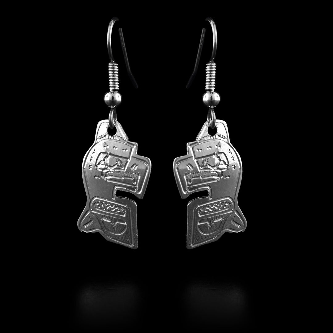 These Eagle dangle earrings have Eagle shaped hangs and are made from sterling silver. The Eagle legend is also carved into the hangs at a side profile with its large head at the top and a smaller wing and tail detail below it.