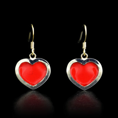 These fine silver hook earrings have red enamel heart shaped hangs. 