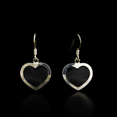These fine silver and enamel hook earrings have the shape of hearts. The hearts are black.