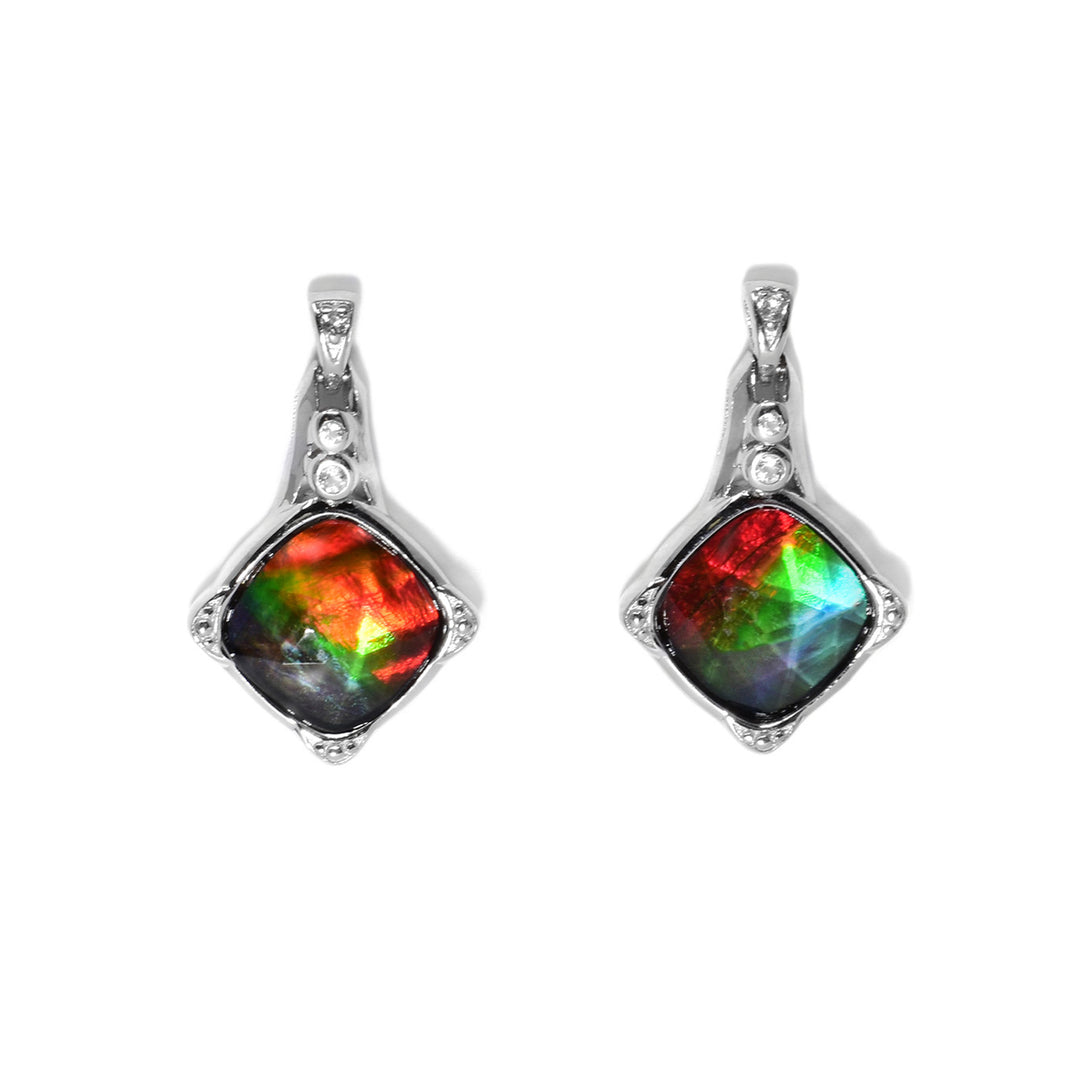 These ammolite stud earrings are diamond-shaped and are a mix of red, orange, green, blue, and purple. Each earring has two small white topaz set at the top.