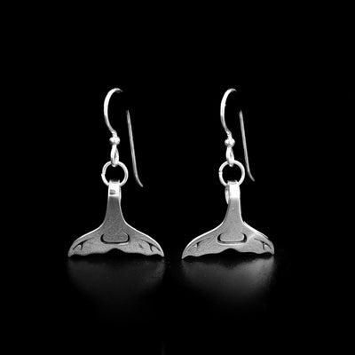 These sterling silver earrings were created by Tahltan artist Grant Pauls.  They hold the shape of a whale tail. The piece measures 0.75" x 1.5" including the hook. 