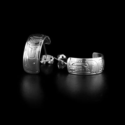 These wide hoop earrings are studs and made from sterling silver and have wide bands curved into half hoop stud earrings. The head of the Orca is carved into the surface and there is a dorsal fin design behind it.