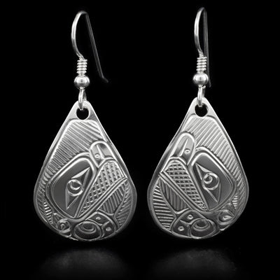 These thunderbird earrings are teardrop in shape and depict the head of a thunderbird with a short, open beak and its wing underneath facing inward.