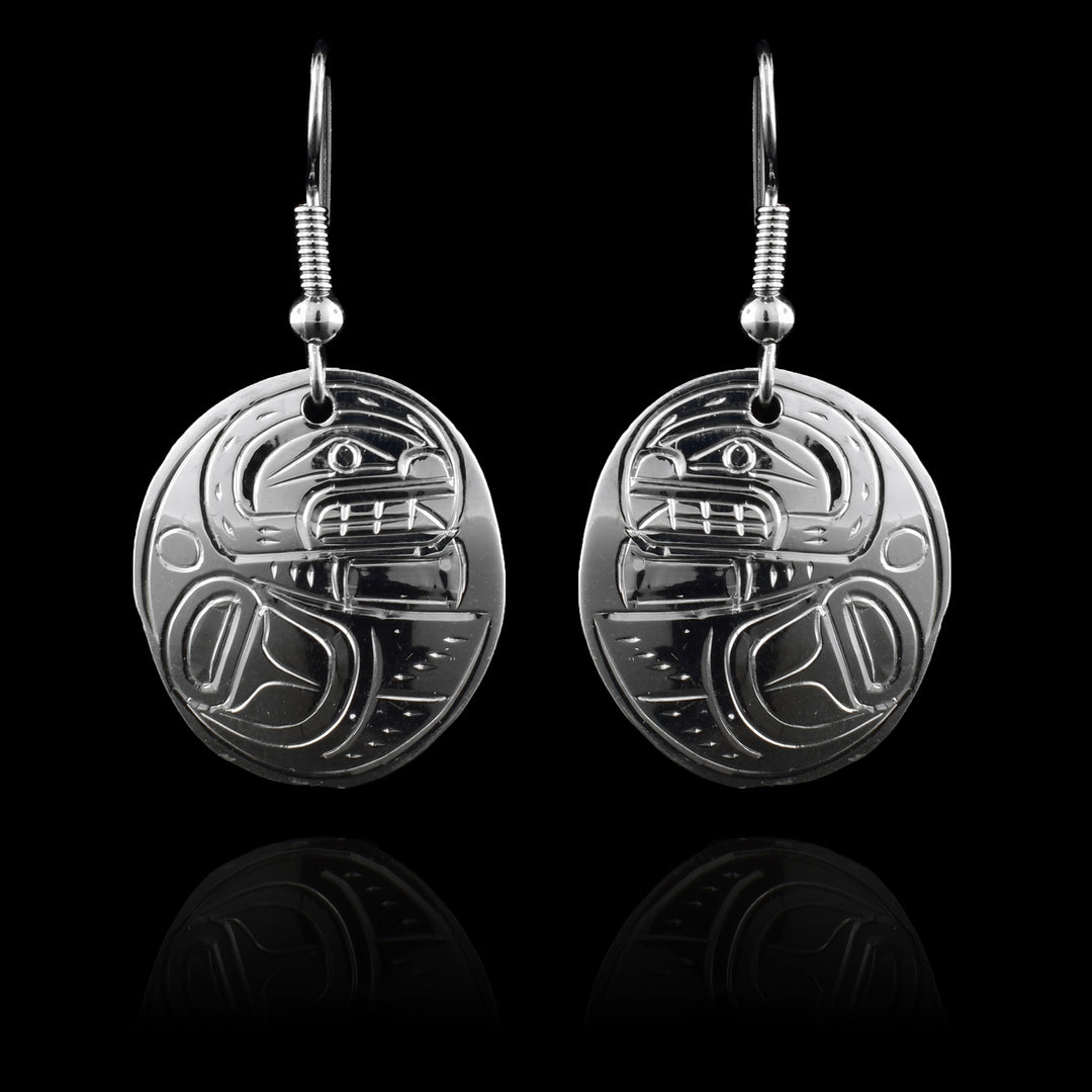 These sterling silver circle earrings have circle shaped hangs that are attached directly to the hooks. The Orca is depicted in the side view with its head at the top of the hangs and its fin wrapped below it.