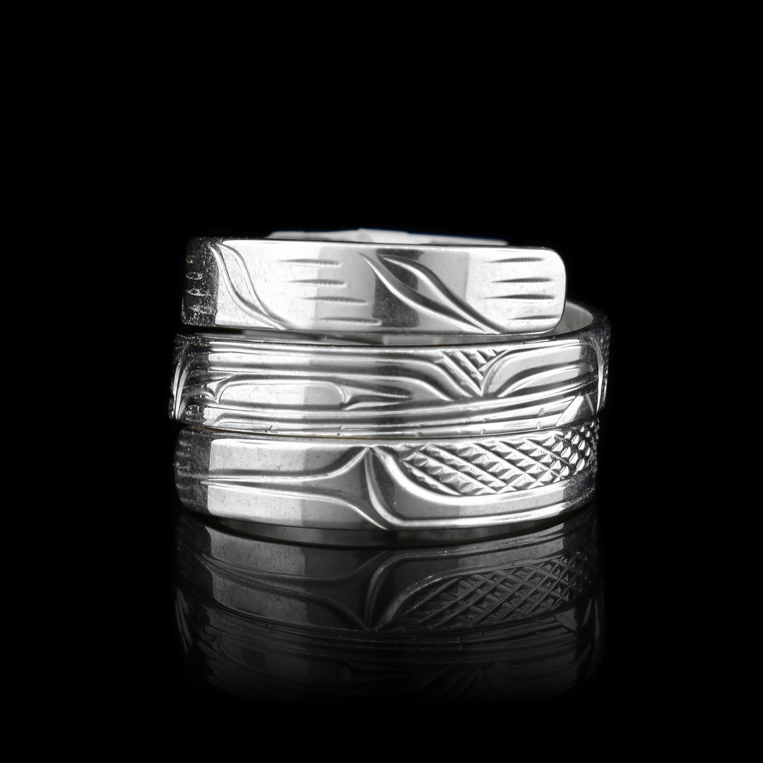 This Wolf ring is made from sterling silver and has a single, thin band that wraps around the finger three times. There is a depiction of the Wolf carved into the surface of the band.