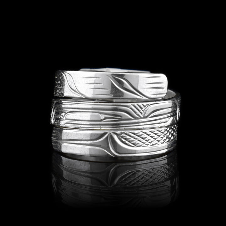 This Wolf ring is made from sterling silver and has a single, thin band that wraps around the finger three times. There is a depiction of the Wolf carved into the surface of the band.