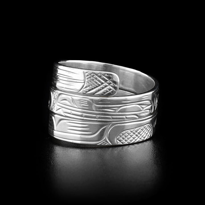 Right side photo of the wrap ring depicts the head of a wolf facing towards the center. The center of the ring is where the wolf's snout and eagle's beak meet.