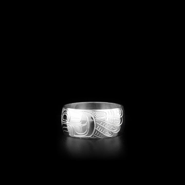 This sterling silver band ring has a wide band width a depiction of the Thunderbird carved into the surface of the band.