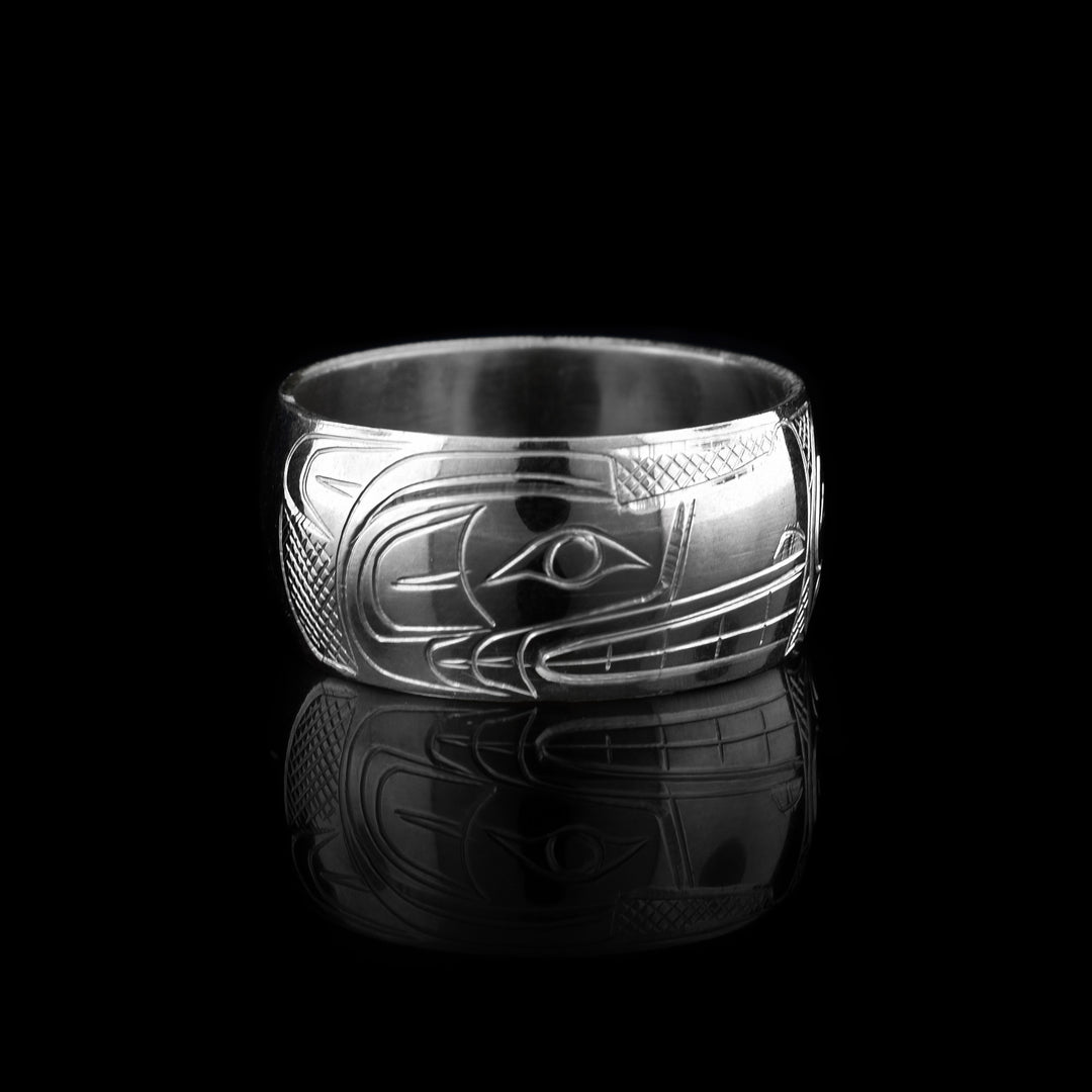 This Moon and Wolf ring is made from sterling silver. It has a wide band and there are depictions of the Wolf and the Moon carved into the surface of it.