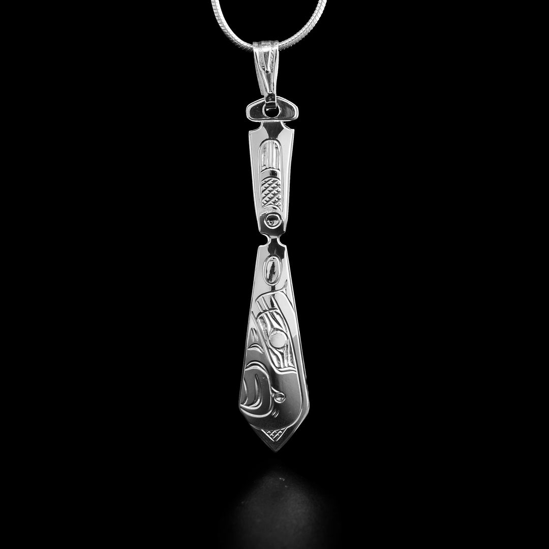 This sterling silver pendant has the Eagle handcarved on it and has the shape of a paddle.