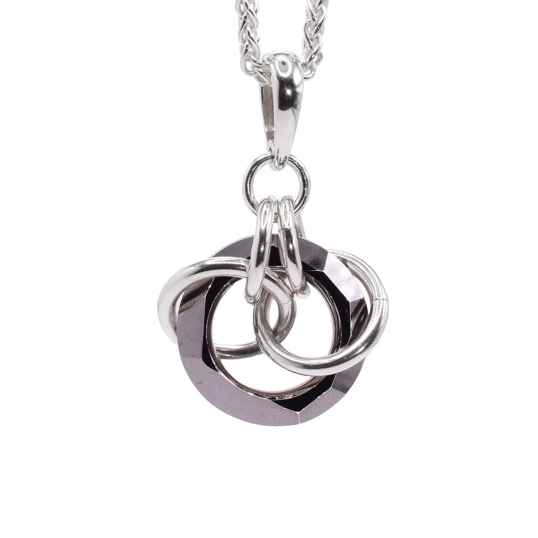 This crystal drop pendant has a hoop shaped charcoal Swarovski crystal. The crystal dangles from a small, sterling silver link with four other large links linked through the crystal pendant.
