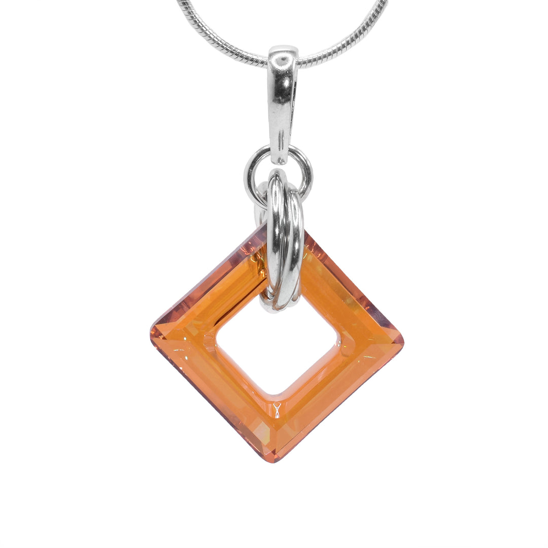 This copper Swarovski crystal drop pendant has a square, cutout Swarovski crystal with multiple sterling silver hoops forming a chain. The crystal dangles from a small link and there are three, larger hoops linked through the crystal.