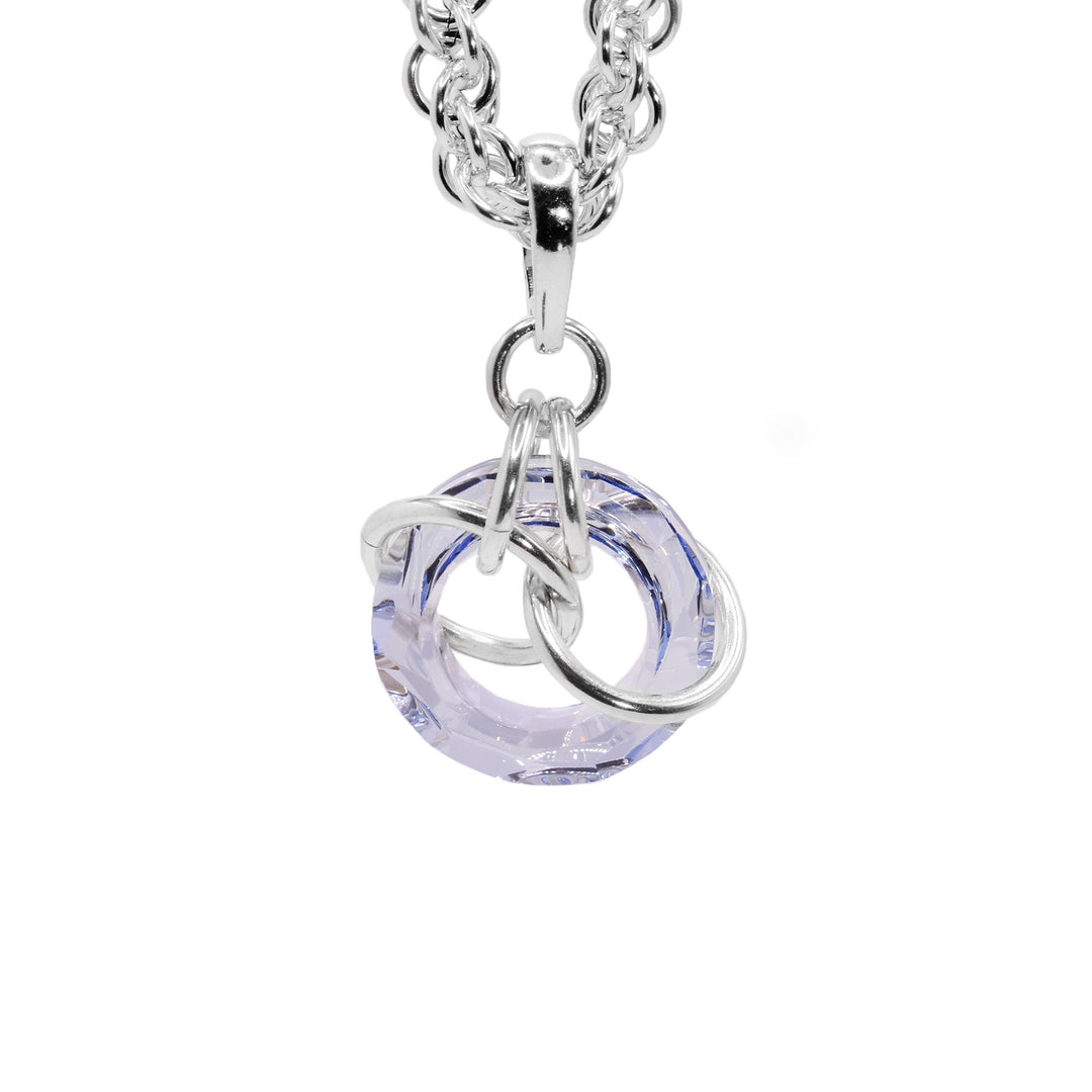 This crystal drop pendant has a hoop shaped blue shade Swarovski crystal. The crystal dangles from a small, sterling silver link with four other large links linked through the crystal pendant.
