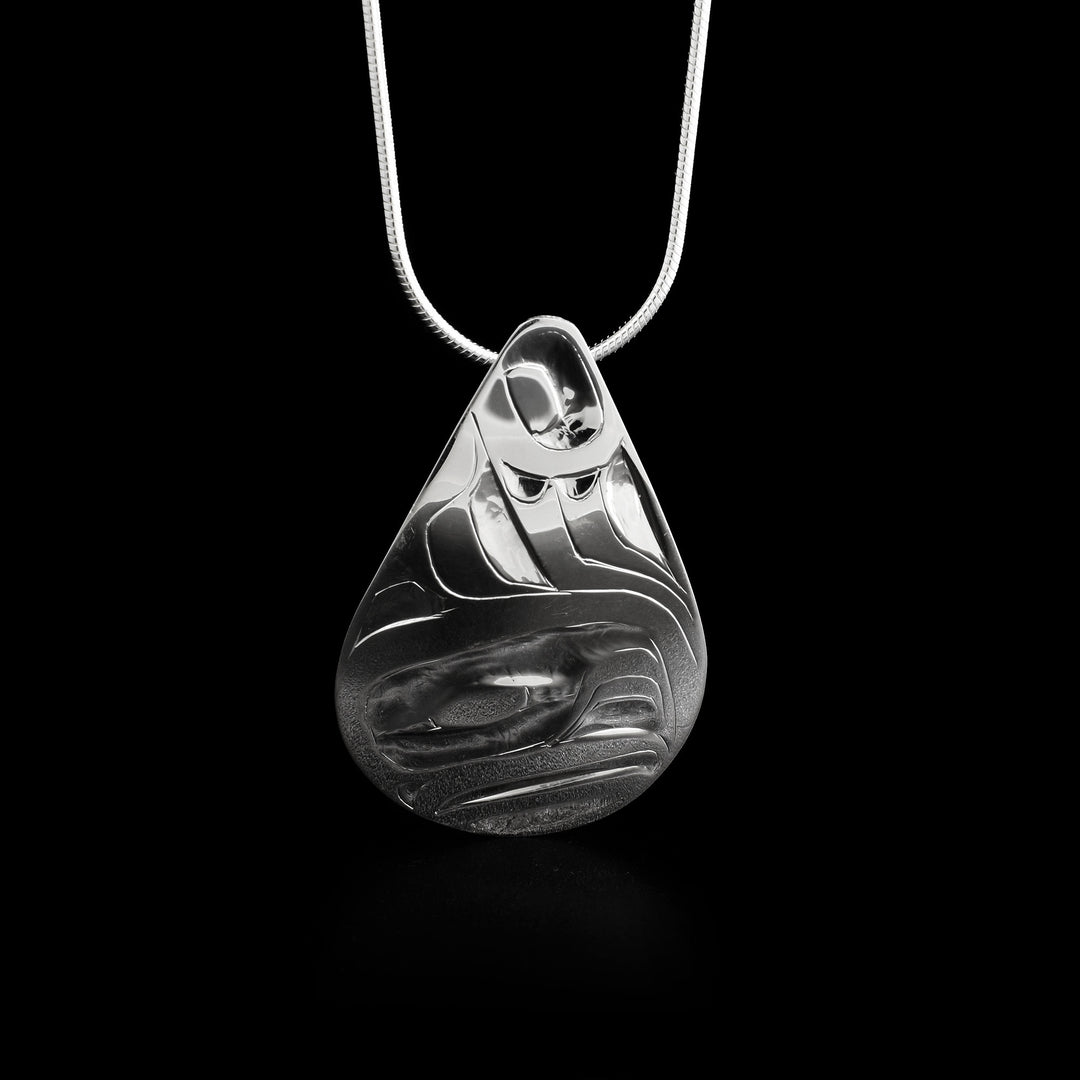 This eagle pendant has the head of an eagle facig the right carved at the bottom of the pendant with its wing above its head.