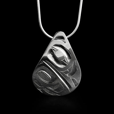 This raven pendant has the head of a raven facing the right in the top half of the pendant with a large wing underneath.