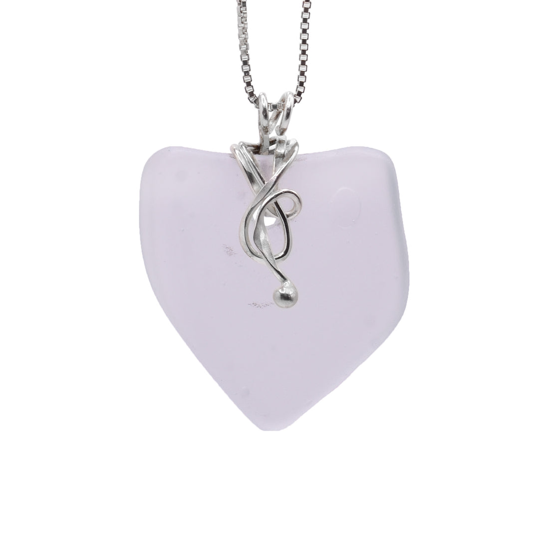 This sea glass pendant has an uneven square shaped piece of pink sea glass as the pendant. There is a dainty, sterling silver charm at the top of the piece that resembles a tangled piece of bull kelp (Sea Kelp). This piece also acts as the bail.