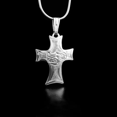 This piece was handcarved on sterling silver. The pendant holds the shape of a cross with a bear carved in the middle.      The pendant measures 1 1/2" x 1". 