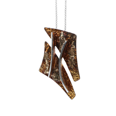 This oxidized silver necklace is made up of two orange and light-brown triangular shaped pieces joined together by two parallel silver lines in the center.