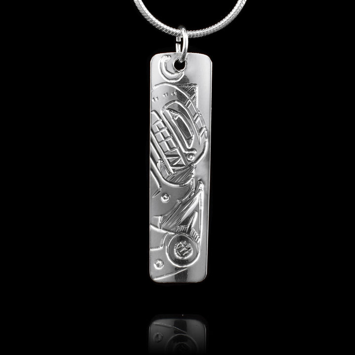 This sterling silver pendant is a small rectangle. There is a depiction of the Eagle and a depiction of the Orca carved onto to either side of this double sided, carved pendant.