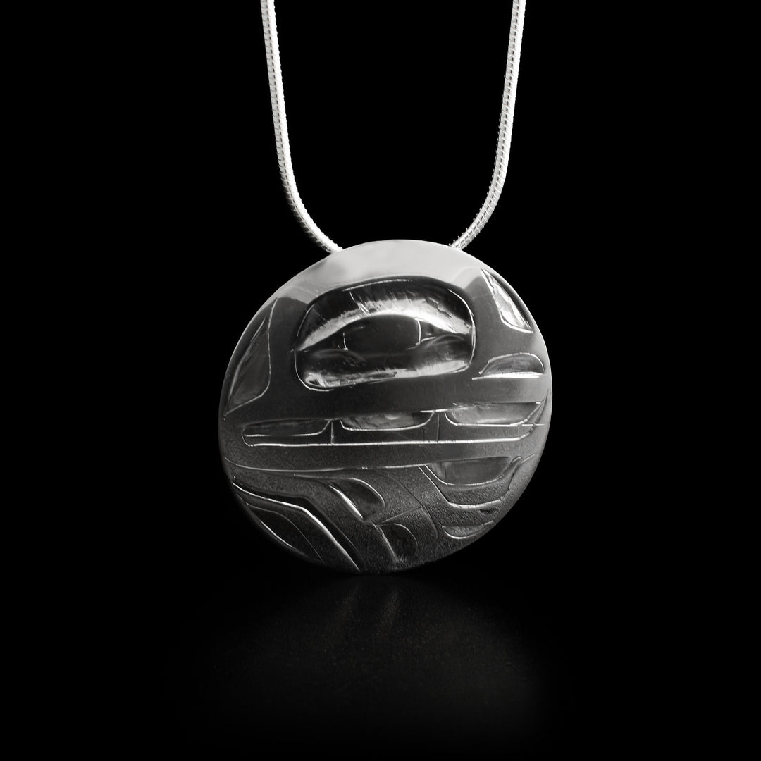 This bear pendant has the head of a bear facing the right in the upper half of the pendant and its large paw beneath it.