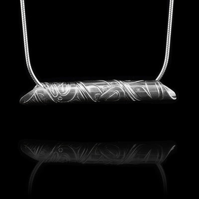 This sterling silver spiral pendant is made our of a strip of sterling silver. The strip of sterling silver depicts the head and body of the Wolf. The strip is coiled into a cylinder shape.