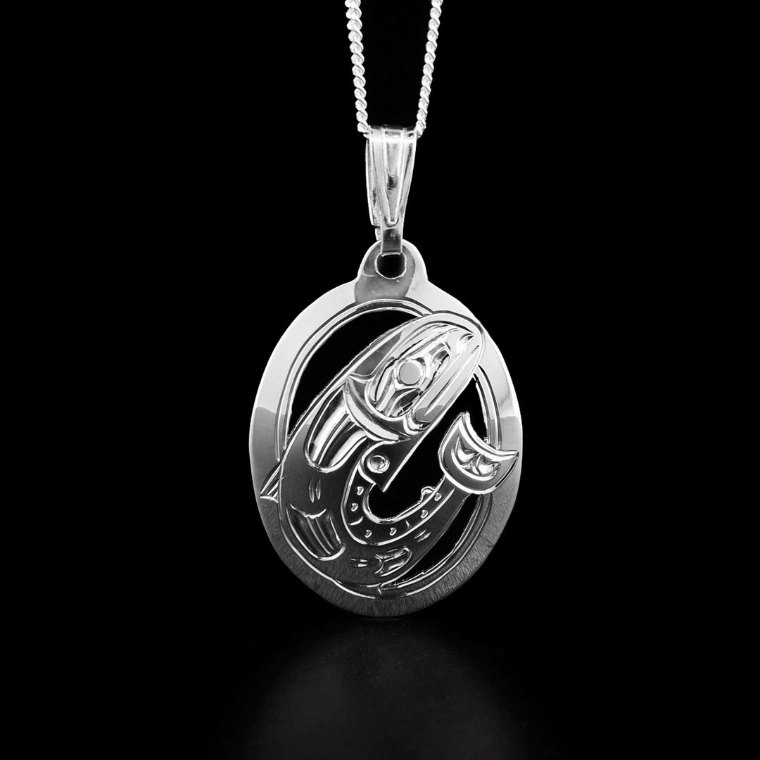 This Salmon fish pendant is oval in shape and depicts a full-bodied Salmon facing the left when worn. The background has been cut out for depth.