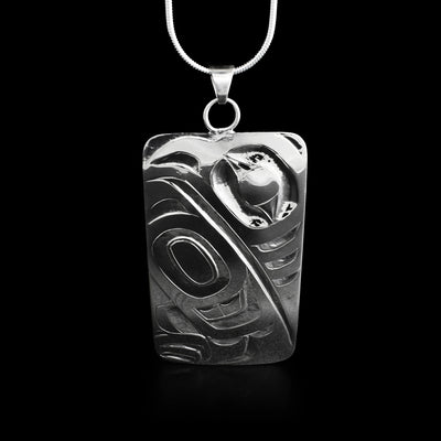 This eagle pendant has the head of an eagle facing the left in the top right corner with a large wing underneath.