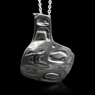 This orca pendant is an abstract shape with the body of the orca being square-shaped and a fin protruding from the top. The design depicts the face and body of an orca facing the right.