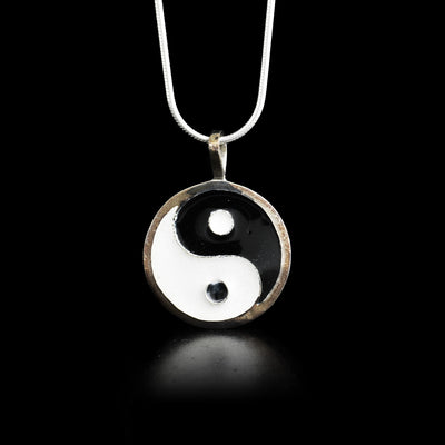 This fine silver and enamel pendant depicts the Chinese symbol Yin Yang. 