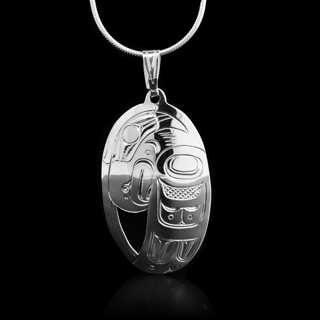 This oval pendant has the head of the Eagle as well as its wing handcarved on it. It measures 2" x 1".    